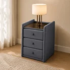 Grey velvet bedside table with tempered glass top in warm bedroom setting
