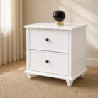 Classic white two drawer bedside table in warm bedroom setting