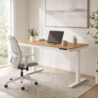 Height adjustable desk with timber top, white frame and office chair in warm home office