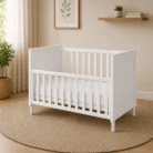 Wooden drop side baby cot in white with lowered front rail