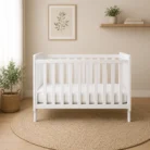 Wooden drop side baby cot in white front view